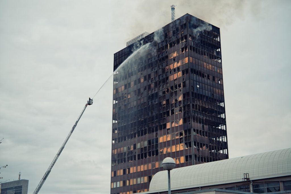 firefighters-spray-water-on-burning-skyscraper-with-broken-windows-iy-moz-gwda